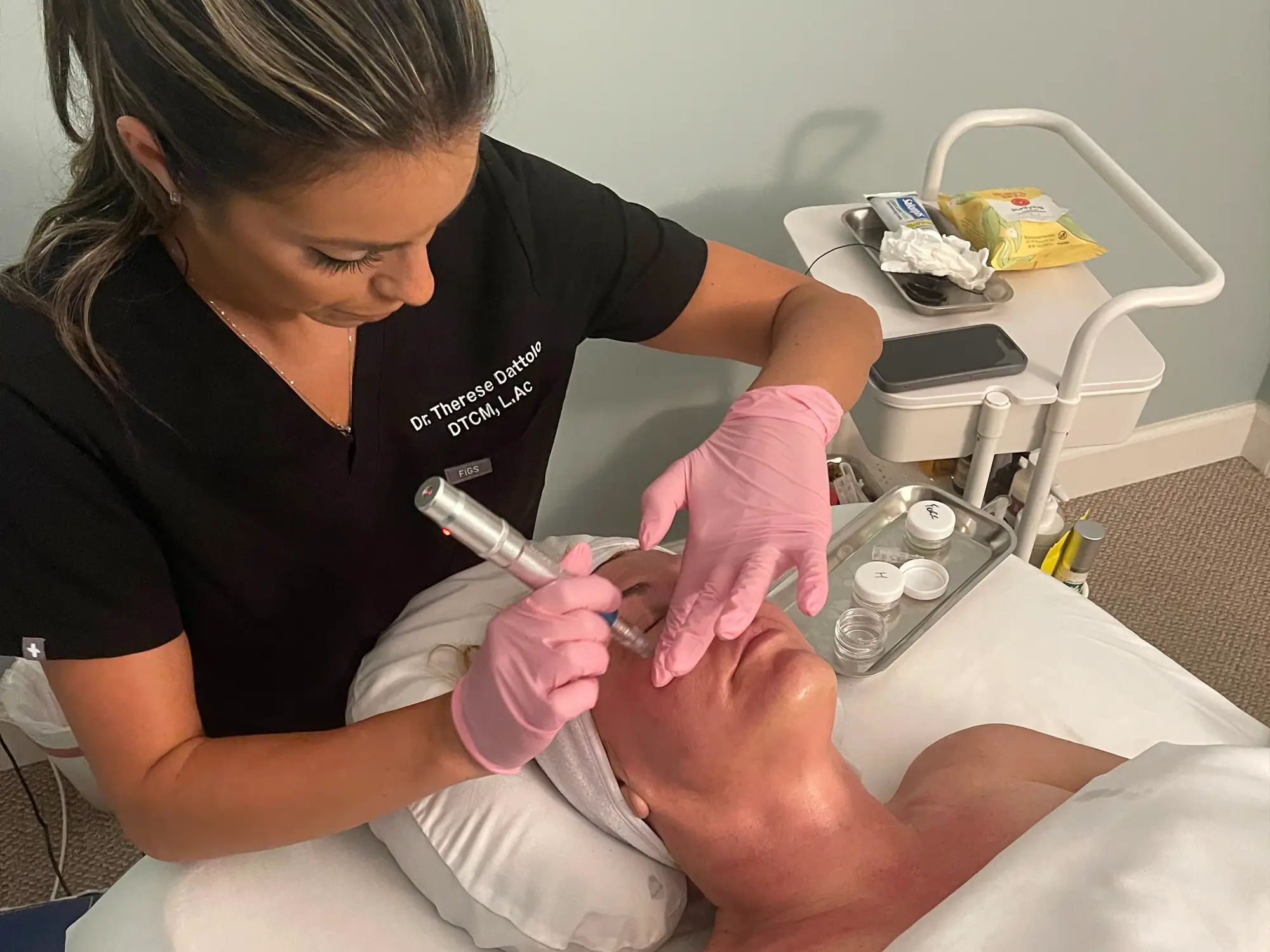 Dr. Therese Dattolo micro needling a patient's face
